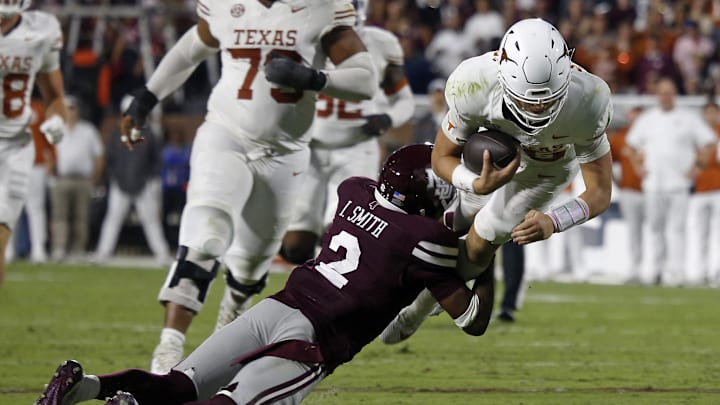 Oct 25, 2025; Starkville, Mississippi, USA; Texas Longhorns quarterback Arch Manning (16) runs the ball as Mississippi State Bulldogs defensive back Isaac Smith (2) makes the tackle. Oct 25, 2025; Starkville, Mississippi, USA; Texas Longhorns quarterback Arch Manning (16) runs the ball as Mississippi State Bulldogs defensive back Isaac Smith (2) makes the tackle.