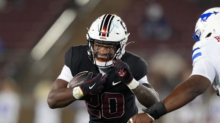 Oct 19, 2024; Stanford, California, USA; Stanford Cardinal running back Micah Ford (20) carries the ball against Southern Methodist Mustangs defensive tackle Kori Roberson Jr. (right) during the third quarter at Stanford Stadium. Mandatory Credit: Darren Yamashita-Imagn Images Oct 19, 2024; Stanford, California, USA; Stanford Cardinal running back Micah Ford (20) carries the ball against Southern Methodist Mustangs defensive tackle Kori Roberson Jr. (right) during the third quarter at Stanford Stadium. Mandatory Credit: Darren Yamashita-Imagn Images