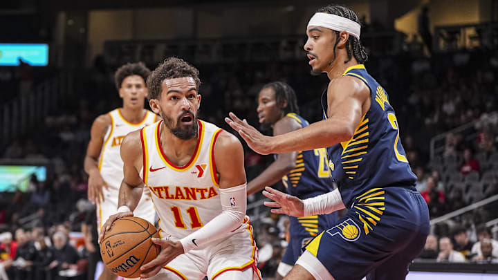 Oct 8, 2024; Atlanta, Georgia, USA; Atlanta Hawks guard Trae Young (11) looks for a play against Indiana Pacers guard Andrew Nembhard (2) during the first half at State Farm Arena. Mandatory Credit: Dale Zanine-Imagn Images