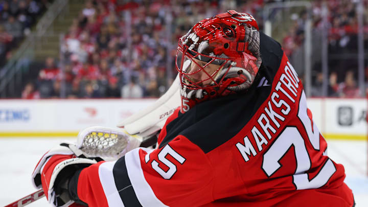 Apr 25, 2025; Newark, New Jersey, USA; New Jersey Devils goaltender Jacob Markstrom (25) plays the puck against the Carolina Hurricanes during the third period in game three of the first round of the 2025 Stanley Cup Playoffs at Prudential Center. Mandatory Credit: Ed Mulholland-Imagn Images