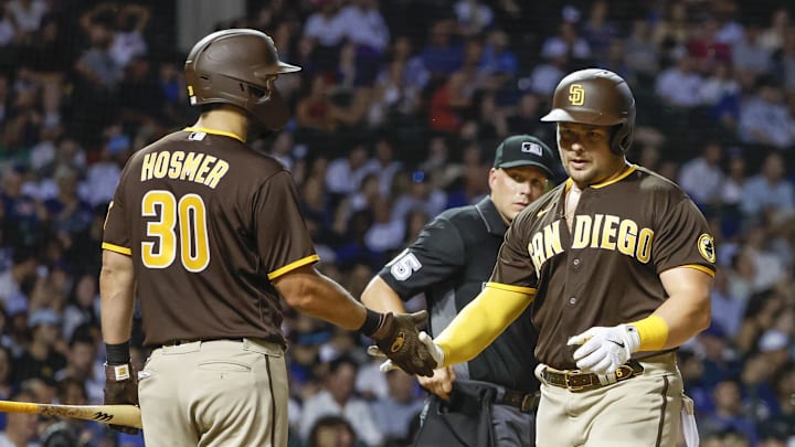 Jun 14, 2022; Chicago, Illinois, USA; San Diego Padres first baseman Luke Voit (45) is congratulated by first baseman Eric Hosmer (30) after hitting a two-run home run against the Chicago Cubs during the sixth inning at Wrigley Field. Mandatory Credit: Kamil Krzaczynski-Imagn Images