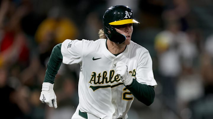 May 23, 2025; West Sacramento, California, USA; Athletics CJ Alexander (26) runs to first after hitting a single against the Philadelphia Phillies during the ninth inning at Sutter Health Park. Mandatory Credit: Dennis Lee-Imagn Images