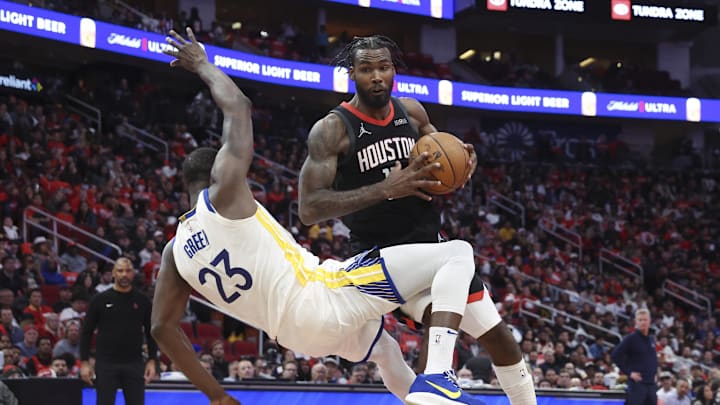 Dec 11, 2024; Houston, Texas, USA; Houston Rockets forward Tari Eason (17) controls the ball as Golden State Warriors forward Draymond Green (23) loses balance during the fourth quarter at Toyota Center. Mandatory Credit: Troy Taormina-Imagn Images