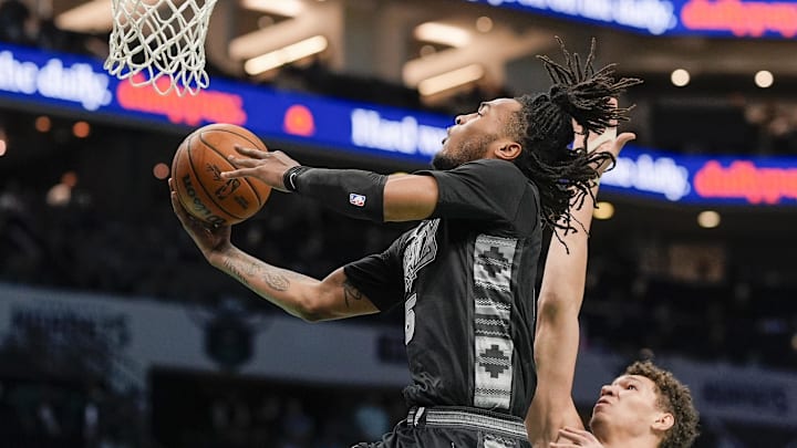 Feb 7, 2025; Charlotte, North Carolina, USA; San Antonio Spurs guard Stephon Castle (5) drives to the basket against Charlotte Hornets forward Tidjane Salaun (31) during the second half at Spectrum Center.
