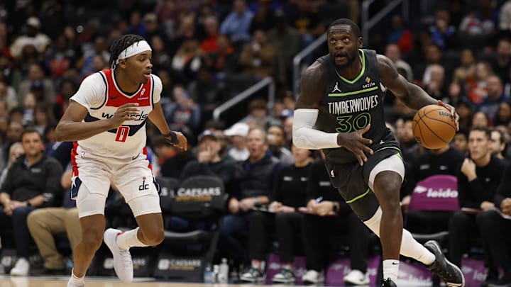 Jan 13, 2025; Washington, District of Columbia, USA; Minnesota Timberwolves forward Julius Randle (30) drives to the basket as Washington Wizards guard Bilal Coulibaly (0) defends in the fourth quarter at Capital One Arena. Mandatory Credit: Geoff Burke-Imagn Images