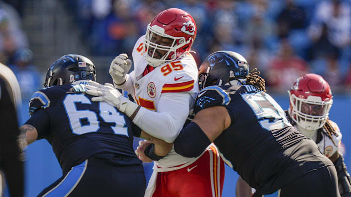 Nov 24, 2024; Charlotte, North Carolina, USA; Kansas City Chiefs defensive tackle Chris Jones (95) is double teamed by Carolina Panthers guard Cade Mays (64) and guard Robert Hunt (50) during the first quarter at Bank of America Stadium. Mandatory Credit: Jim Dedmon-Imagn Images