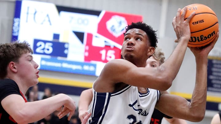 PCA's Chris Washington Jr. (33) looks before going up for a shot as Grace Christian Academy's Chase Benham (30) guards him during the boys' basketball game on Friday, Feb. 6, 2026.