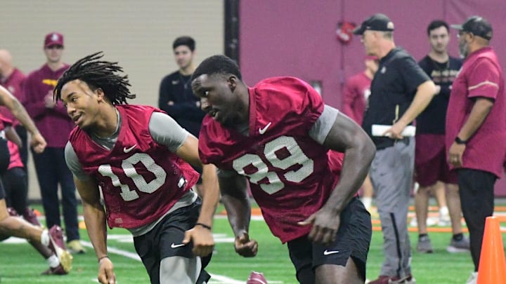Florida State football quarterback Trever Jackson (left) and tight end Jerrale Powers take part in