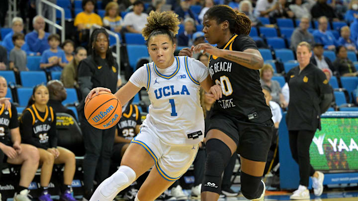 Dec 20, 2025; Los Angeles, California, USA; UCLA Bruins guard Kiki Rice (1) is defended by Long Beach State Beach guard Jaquoia Jones-Brown (30) as she drives to the basket during the first half at Pauley Pavilion presented by Wescom Financial. Mandatory Credit: Jayne Kamin-Oncea-Imagn Images