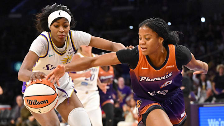 Aug 26, 2025; Los Angeles, California, USA; Los Angeles Sparks forward Rickea Jackson (2)and Phoenix Mercury guard Monique Akoa Makani (8) reach for a loose ball during the second half at Crypto.com Arena. Mandatory Credit: Jayne Kamin-Oncea-Imagn Images