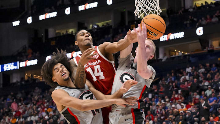 Mar 12, 2025; Nashville, TN, USA;  Oklahoma Sooners forward Jalon Moore (14), Georgia Bulldogs forward Asa Newell (14), and guard Blue Cain (0) fight for the ball during the second half at Bridgestone Arena. Mandatory Credit: Steve Roberts-Imagn Images