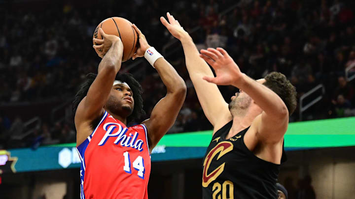 Dec 21, 2024; Cleveland, Ohio, USA; Philadelphia 76ers guard Ricky Council IV (14) shoots over the defense of Cleveland Cavaliers forward Georges Niang (20) during the first half at Rocket Mortgage FieldHouse. Mandatory Credit: Ken Blaze-Imagn Images