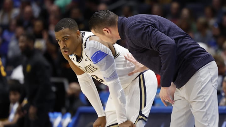 Mar 20, 2024; Dayton, OH, USA; Montana State Bobcats head coach Matt Logie talks with guard Eddie Turner III (3) before enter the game in the second half at UD Arena. Mandatory Credit: Rick Osentoski-Imagn Images