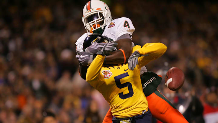 Dec. 27, 2008; San Francisco, CA, USA; Miami Hurricanes wide receiver Aldarius Johnson (4) fights for the pass with California Golden Bears cornerback Syd'quan Thompson (5) during the second quarter in the 2008 Emerald Bowl at AT&T Park in San Francisco, CA. Mandatory Credit: Phil Carter-Imagn Images