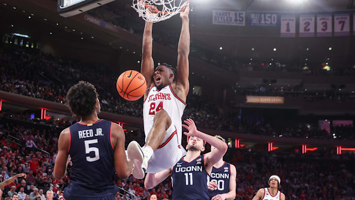 Feb 23, 2025; New York, New York, USA;  St. John's basketball forward Zuby Ejiofor (24) dunks past Connecticut Huskies forward Alex Karaban (11) in the second half at Madison Square Garden. 