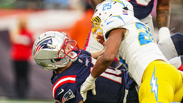 Dec 28, 2024; Foxborough, Massachusetts, USA; New England Patriots quarterback Drake Maye (10) on the field against Los Angeles Chargers linebacker Junior Colson (25) second half at Gillette Stadium. Mandatory Credit: David Butler II-Imagn Images