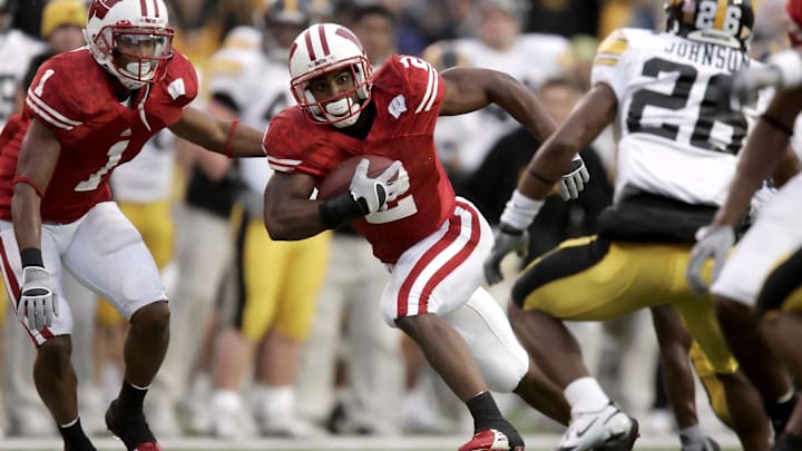 November 12, 2005; Madison, WI, USA; Wisconsin Badgers running back Brian Calhoun (2) carries the ball after catching a pass as Iowa Hawkeyes defensive back #26 Jovon Johnson looks on during the second quarter at Camp Randall Stadium. November 12, 2005; Madison, WI, USA; Wisconsin Badgers running back Brian Calhoun (2) carries the ball after catching a pass as Iowa Hawkeyes defensive back #26 Jovon Johnson looks on during the second quarter at Camp Randall Stadium.