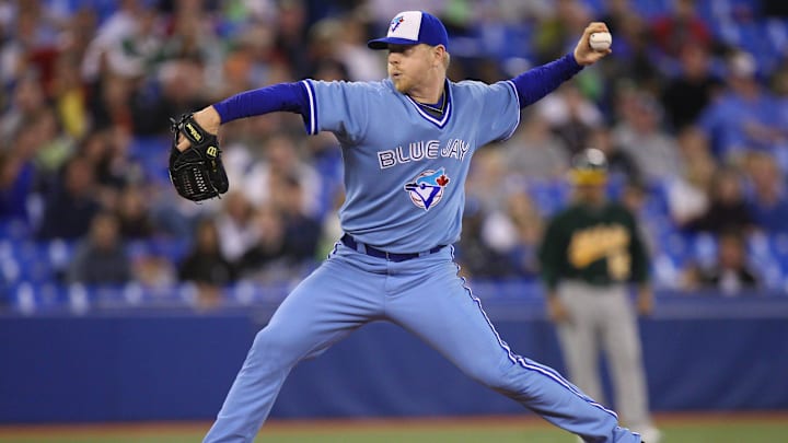 Former Toronto Blue Jays pitcher David Purcey throws a pitch wearing a powder blue jersey and white and blue hat. Former Toronto Blue Jays pitcher David Purcey throws a pitch wearing a powder blue jersey and white and blue hat.