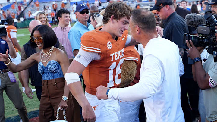 Texas Longhorns quarterback Arch Manning (16) hugs Texas head coach Stephen Sarkisian following the Red River Rivalry, Texas Longhorns quarterback Arch Manning (16) hugs Texas head coach Stephen Sarkisian following the Red River Rivalry,