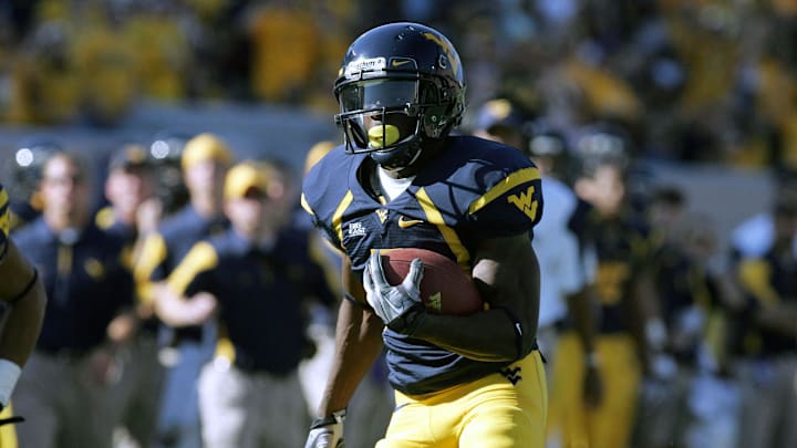 October 9, 2010; Morgantown,WV, USA; West Virginia Mountaineers running back Noel Devine (7) rushes for a first quarter touchdown during the game against the UNLV Rebels at Mountaineer Field at Milan Puskar Stadium. Mandatory Credit: Charles LeClaire-USPRESSWIRE