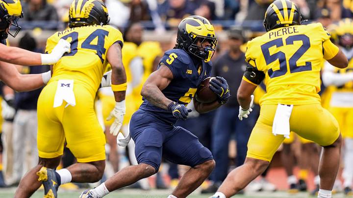 Team Blue running back Savion Hiter (5) runs against Team Maize during the spring game at Michigan Stadium in Ann Arbor on Saturday, April 18, 2026.