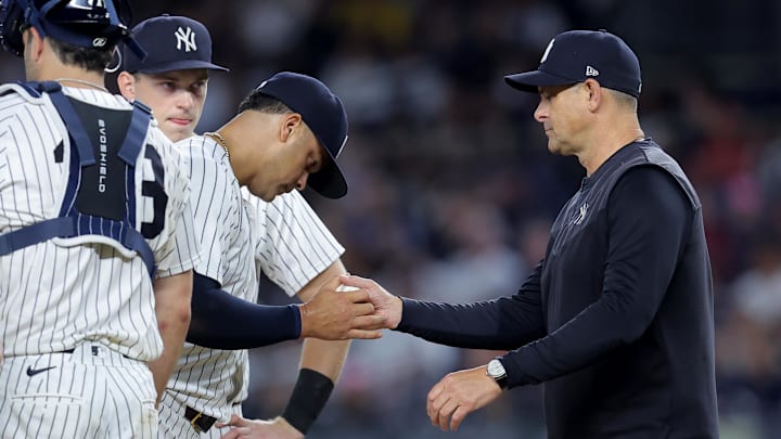 Sep 9, 2025; Bronx, New York, USA; New York Yankees manager Aaron Boone (17) takes the ball from relief pitcher Fernando Cruz (63) during a pitching change during the seventh inning against the Detroit Tigers at Yankee Stadium. Mandatory Credit: Brad Penner-Imagn Images
