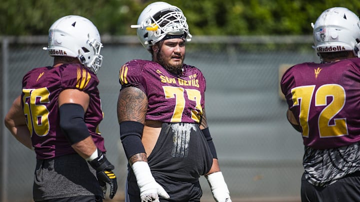 The Arizona State University football team practices in Tempe, Monday, August 19, 2019. Offensive linemen Alex Losoya, left, and Cohl Cabral, middle, talk between plays.

Asu