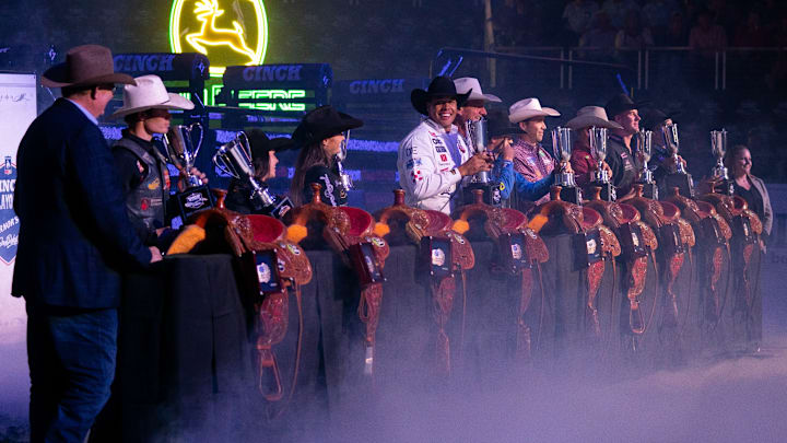 Champion cowboys and cowgirls stand in line accepting their trophies and saddles at the CINCH Playoffs Finals in Sioux Falls. Champion cowboys and cowgirls stand in line accepting their trophies and saddles at the CINCH Playoffs Finals in Sioux Falls.