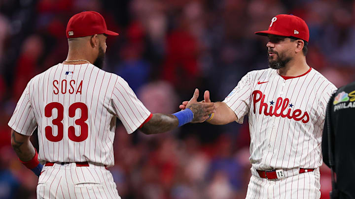 Philadelphia Phillies short stop Edmundo Sosa (33) and outfielder Kyle Schwarber (12) celebrate a victory against the Miami Marlins at Citizens Bank Park. 