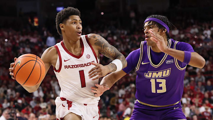 Arkansas guard Meleek Thomas (1) drives against James Madison forward Preston Fowler (13) during the first half at Bud Walton Arena. 