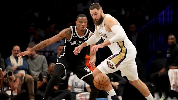 Oct 19, 2022; Brooklyn, New York, USA; New Orleans Pelicans center Jonas Valanciunas (17) chases a loose ball against Brooklyn Nets forward Nic Claxton (33) during the second quarter at Barclays Center. Mandatory Credit: Brad Penner-Imagn Images