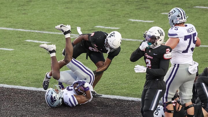 Nov 2, 2024; Houston, Texas, USA; Kansas State Wildcats running back DJ Giddens (31) rushes for a touchdown against Houston Cougars defensive back Kentrell Webb (8)in the second quarter at TDECU Stadium. Mandatory Credit: Thomas B. Shea-Imagn Images