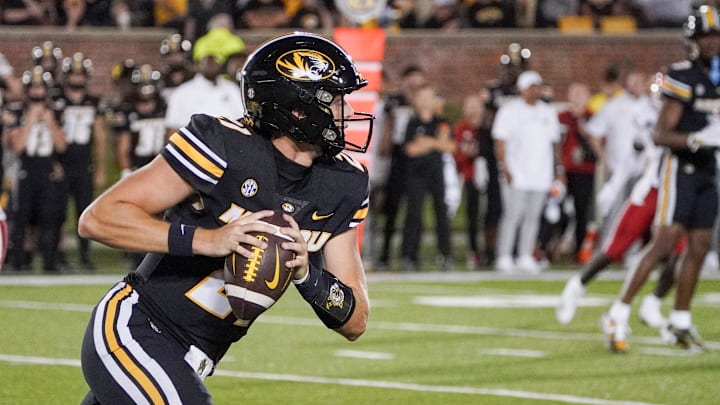 Aug 31, 2023; Columbia, Missouri, USA; Missouri Tigers quarterback Sam Horn (21) runs the ball against the South Dakota Coyotes during the game at Faurot Field at Memorial Stadium. Mandatory Credit: Denny Medley-Imagn Images