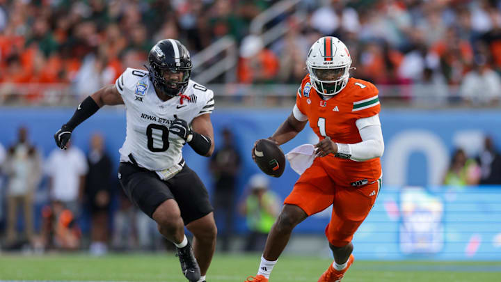 Dec 28, 2024; Orlando, FL, USA; Miami Hurricanes quarterback Cam Ward (1) runs with the ball against the Iowa State Cyclones in the second quarter during the Pop Tarts bowl at Camping World Stadium. Mandatory Credit: Nathan Ray Seebeck-Imagn Images