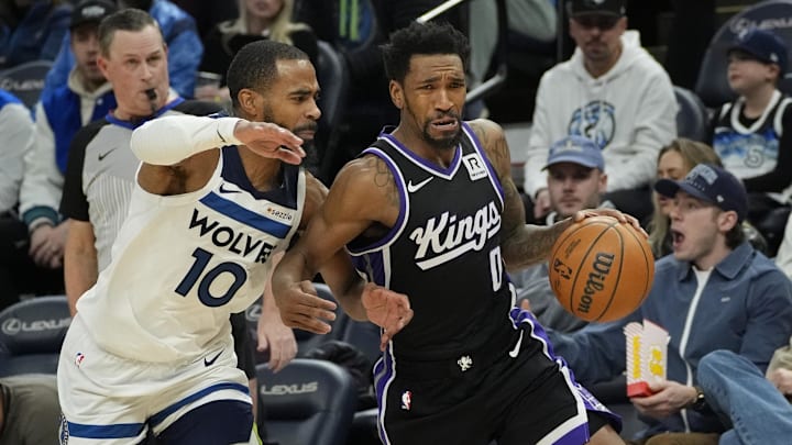 Feb 3, 2025; Minneapolis, Minnesota, USA; Sacramento Kings guard Malik Monk (0) works past Minnesota Timberwolves guard Mike Conley (10) in the third quarter at Target Center. Mandatory Credit: Bruce Kluckhohn-Imagn Images