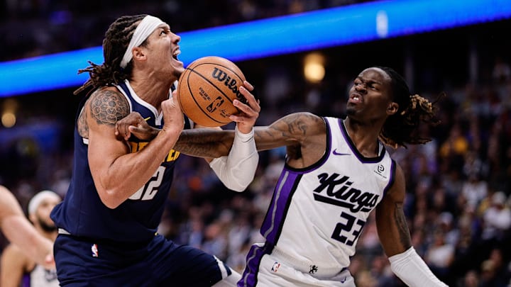 Nov 3, 2025; Denver, Colorado, USA; Denver Nuggets forward Aaron Gordon (32) is fouled by Sacramento Kings guard Keon Ellis (23) in the second quarter at Ball Arena. Mandatory Credit: Isaiah J. Downing-Imagn Images