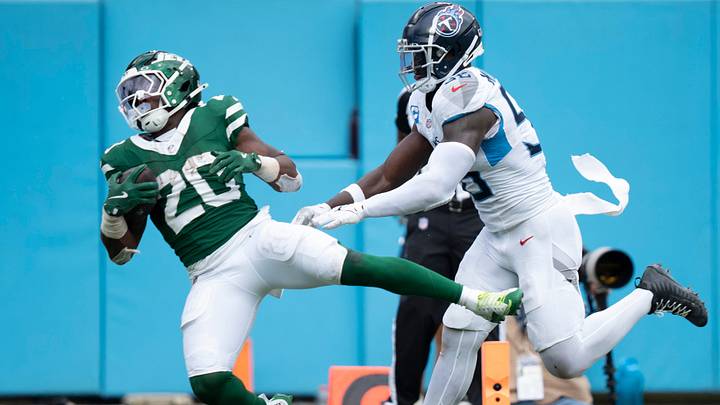 New York Jets running back Breece Hall (20) comes down with a touchdown pass while defended by Tennessee Titans linebacker Kenneth Murray Jr. (56) during their game at Nissan Stadium in Nashville, Tenn., Sunday, Sept. 15, 2024.