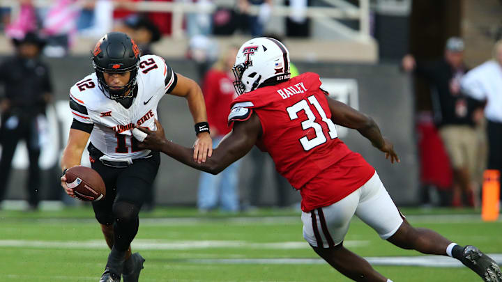 Oct 25, 2025; Lubbock, Texas, USA; Texas Tech Red Raiders defensive end David Bailey (31) pressures  Oklahoma State Cowboys quarterback Noah Walters (12) in the second half at Jones AT&T Stadium. Mandatory Credit: Michael C. Johnson-Imagn Images Oct 25, 2025; Lubbock, Texas, USA; Texas Tech Red Raiders defensive end David Bailey (31) pressures  Oklahoma State Cowboys quarterback Noah Walters (12) in the second half at Jones AT&T Stadium. Mandatory Credit: Michael C. Johnson-Imagn Images