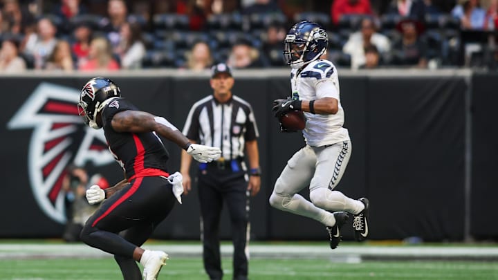 Oct 20, 2024; Atlanta, Georgia, USA; Seattle Seahawks cornerback Coby Bryant (8) intercepts a pass intended for Atlanta Falcons tight end Kyle Pitts (8) in the fourth quarter at Mercedes-Benz Stadium. Mandatory Credit: Brett Davis-Imagn Images