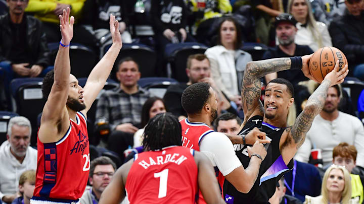 Feb 13, 2025; Salt Lake City, Utah, USA; LA Clippers guard Norman Powell (24), guard James Harden (1), and guard/forward Ben Simmons (25) defend Utah Jazz forward/center John Collins (20) during the second half at the Delta Center. Mandatory Credit: Christopher Creveling-Imagn Images
