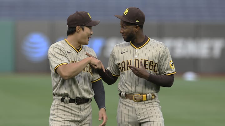 Apr 12, 2021; Pittsburgh, Pennsylvania, USA;  San Diego Padres second baseman Ha-Seong Kim (left) and left fielder Jurickson Profar (10) joke around on the field before playing the Pittsburgh Pirates at PNC Park. Mandatory Credit: Charles LeClaire-Imagn Images