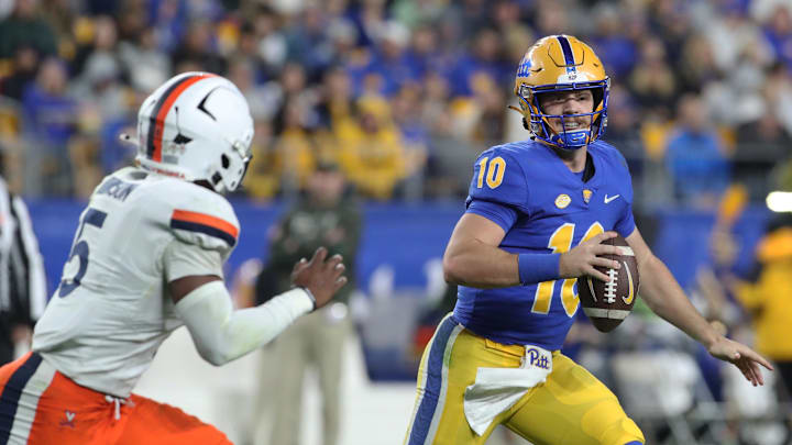 Nov 9, 2024; Pittsburgh, Pennsylvania, USA; Pittsburgh Panthers quarterback Eli Holstein (10) scrambles with the ball as Virginia Cavaliers linebacker Kam Robinson (5) chases during the second quarter at Acrisure Stadium. Mandatory Credit: Charles LeClaire-Imagn Images Nov 9, 2024; Pittsburgh, Pennsylvania, USA; Pittsburgh Panthers quarterback Eli Holstein (10) scrambles with the ball as Virginia Cavaliers linebacker Kam Robinson (5) chases during the second quarter at Acrisure Stadium. Mandatory Credit: Charles LeClaire-Imagn Images