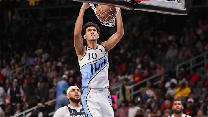 Nov 25, 2024; Atlanta, Georgia, USA; Atlanta Hawks forward Zaccharie Risacher (10) dunks against the Dallas Mavericks in the third quarter at State Farm Arena. Mandatory Credit: Brett Davis-Imagn Images