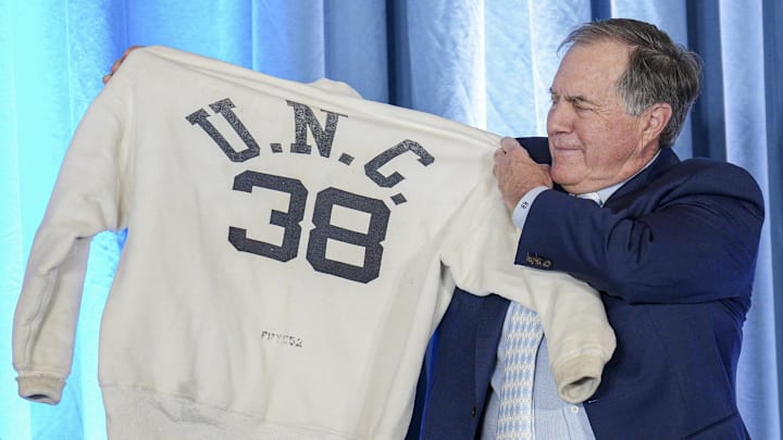 Dec 12, 2024; Chapel Hill, NC, USA;   North Carolina Tar Heels new head coach Bill Belichick holds up the sweatshirt worn by his father when he was an assistant coach at New North Carolina Tar Heels new at Loudermilk Center for Excellence. 