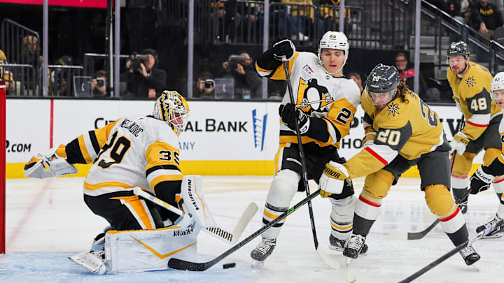 Alex Nedeljkovic (left) saves shot from Brandon Saad (right) during Pittsburgh Penguins v Vegas Golden Knights