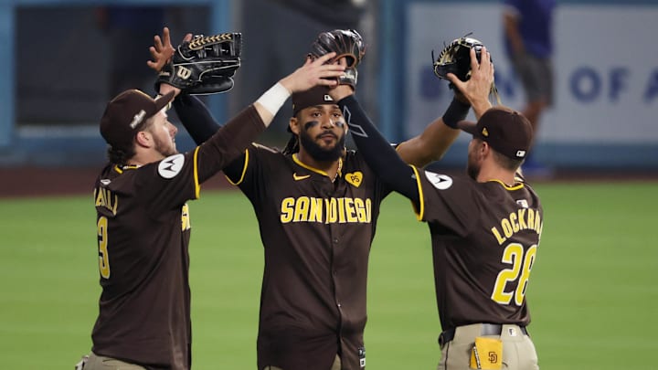 Oct 6, 2024; Los Angeles, California, USA; San Diego Padres outfielder Jackson Merrill (3) and outfielder Fernando Tatis Jr. (23) and outfielder Brandon Lockridge (28) celebrate after defeating the Los Angeles Dodgers in game two of the NLDS for the 2024 MLB Playoffs at Dodger Stadium. Mandatory Credit: Kiyoshi Mio-Imagn Images