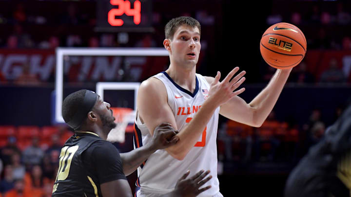 Nov 13, 2024; Champaign, Illinois, USA;  Illinois Fighting Illini center Tomislav Ivisic (13) looks to pass against Oakland Golden Grizzlies guard DQ Cole (10) during the first half at State Farm Center. Mandatory Credit: Ron Johnson-Imagn Images