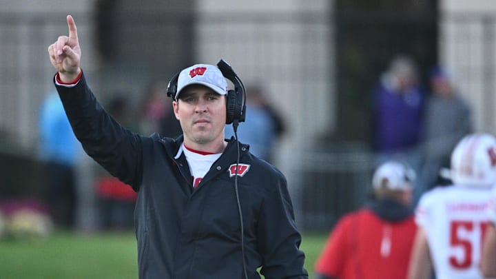 Oct 8, 2022; Evanston, Illinois, USA;  Wisconsin Badgers interim head coach Jim Leonhard singles for an extra point after a touchdown against the Northwestern Wildcats in the fourth quarter at Ryan Field. Mandatory Credit: Jamie Sabau-Imagn Images