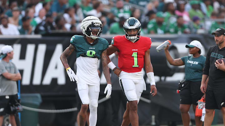 Aug 1, 2024; Philadelphia, PA, USA; Philadelphia Eagles quarterback Jalen Hurts (1) talks with wide receiver DeVonta Smith (6) during a training camp practice at Lincoln Financial Field. Mandatory Credit: Bill Streicher-USA TODAY Sports