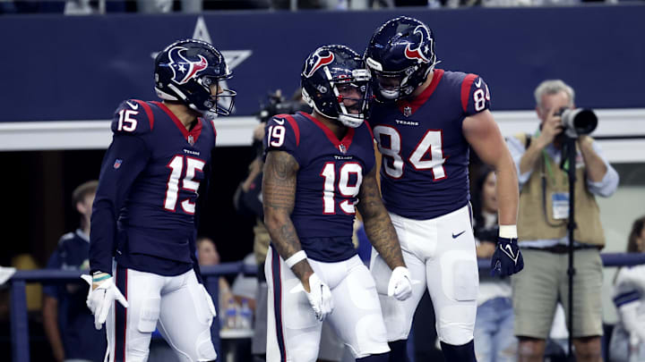 Dec 11, 2022; Arlington, Texas, USA;  Houston Texans wide receiver Amari Rodgers (19)  celebrates with Houston Texans wide receiver Chris Moore (15) and Houston Texans tight end Teagan Quitoriano (84) after catching a touchdown  pass during the first half against the Dallas Cowboys at AT&T Stadium. Mandatory Credit: Kevin Jairaj-Imagn Images